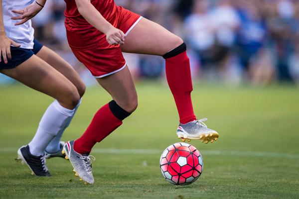 two women playing football