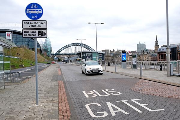 Car driving through bus gate