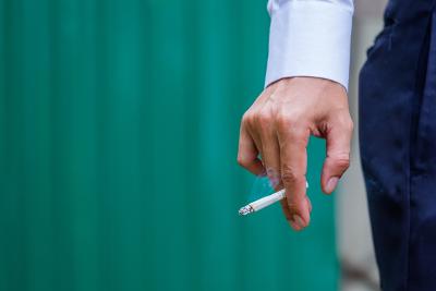 Cigarette in hand in mans hand