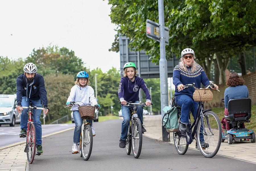 Family cycling on High West Street cycle path