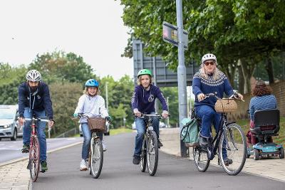 Family cycling on High West Street cycle path