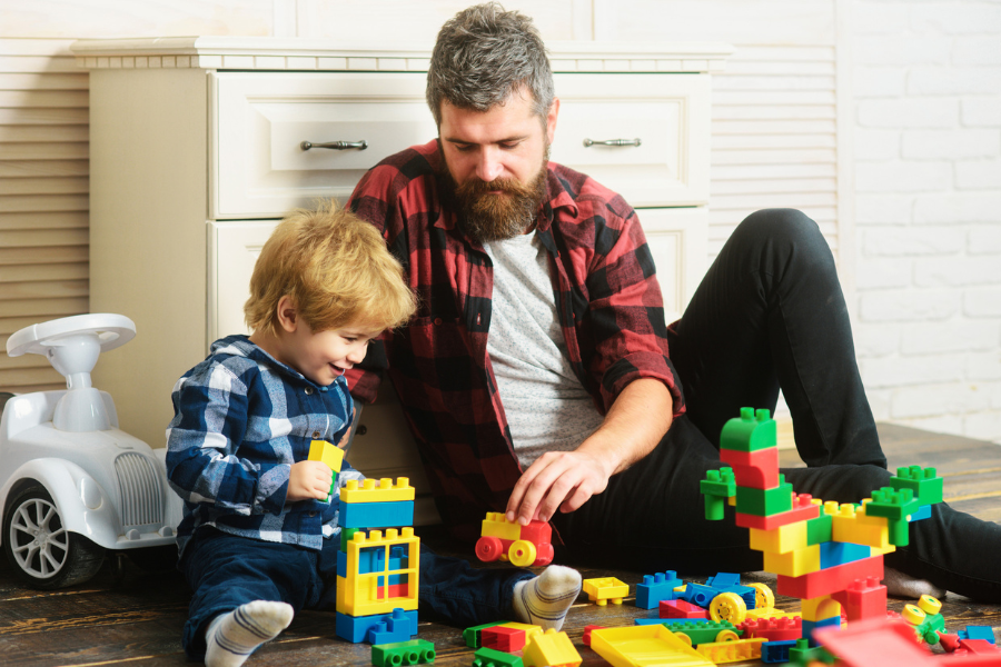 Photo of an adult and a child playing with toys