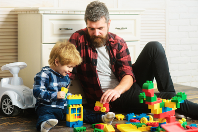 Photo of an adult and a child playing with toys